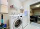Well-equipped laundry room with washer, dryer and access to the garage at 1038 Orange Cosmos Blvd, Davenport, FL 33837