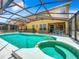 Relaxing screened pool and spa with a view of the house at 1038 Orange Cosmos Blvd, Davenport, FL 33837