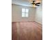 Spacious bedroom with ceiling fan and window shutters at 108 Colonial Pine Ln, Minneola, FL 34715