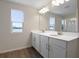 Double vanity bathroom with a large mirror and window at 308 Alexandrite St, Deland, FL 32720