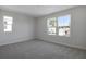 Spacious bedroom with two windows and carpet at 308 Alexandrite St, Deland, FL 32720