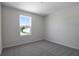 Well-lit bedroom with a window and carpeted floor at 308 Alexandrite St, Deland, FL 32720