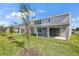 Two-story house with covered patio and grassy backyard at 308 Alexandrite St, Deland, FL 32720