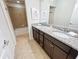Bathroom with granite countertop double vanity and a shower/tub combo at 1921 Nice Ct, Kissimmee, FL 34747