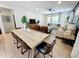 Light and airy dining area with a large wooden table and leather chairs at 1921 Nice Ct, Kissimmee, FL 34747