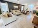 Open concept living room with comfortable seating and adjacent kitchen at 1921 Nice Ct, Kissimmee, FL 34747