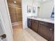 Bathroom boasts dual vanity sinks and a walk-in shower at 1921 Nice Ct, Kissimmee, FL 34747