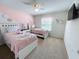 Twin bedroom with unicorn theme, featuring two beds and pink color scheme at 1921 Nice Ct, Kissimmee, FL 34747