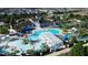 Aerial view of resort-style pool with water features, ' area, and lounge chairs at 1921 Nice Ct, Kissimmee, FL 34747