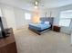 King-size bed in a well-lit bedroom with plenty of room at 1921 Nice Ct, Kissimmee, FL 34747