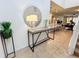 Bright entryway with a modern console table and large round mirror at 1921 Nice Ct, Kissimmee, FL 34747