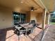 Covered patio with wicker furniture, providing a shaded outdoor dining space at 1921 Nice Ct, Kissimmee, FL 34747