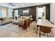 Spacious living room with light tile floors, comfortable seating, and a dining area at 1921 Nice Ct, Kissimmee, FL 34747