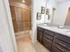Bathroom with dual vanity sinks and a shower/tub combo at 1921 Nice Ct, Kissimmee, FL 34747