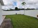 Backyard with grassy lawn and white vinyl fence at 2518 Bowmer Dr, Kissimmee, FL 34744