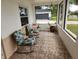 Relaxing screened porch with rocking chairs, perfect for enjoying the Florida weather at 2518 Bowmer Dr, Kissimmee, FL 34744