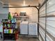Interior laundry room with washer, dryer, and storage shelves at 2518 Bowmer Dr, Kissimmee, FL 34744