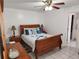 Cozy bedroom with wooden sleigh bed and ceiling fan at 2518 Bowmer Dr, Kissimmee, FL 34744