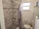 Clean bathroom with marble shower and pebble floor at 2518 Bowmer Dr, Kissimmee, FL 34744