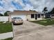 Single-story home with attached garage and spacious driveway at 2518 Bowmer Dr, Kissimmee, FL 34744