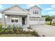 Two-story home with gray siding, stone accents, and a two-car garage at 1446 Maddie Berry Ln, Kissimmee, FL 34744