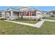 One story home with gray siding, red shutters, and stone accents at 1456 August Gray Dr, Kissimmee, FL 34744