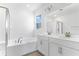 Double vanity, soaking tub, and walk-in shower in this ensuite bathroom at 2027 Stetson Ct, Eagle Lake, FL 33839