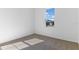 Simple bedroom with neutral colored carpet and a large window at 2027 Stetson Ct, Eagle Lake, FL 33839