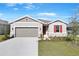 Curb appeal! One-story home with gray siding, red shutters, and a two-car garage at 2027 Stetson Ct, Eagle Lake, FL 33839