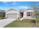 One-story home with gray siding, red shutters, and a two-car garage at 2027 Stetson Ct, Eagle Lake, FL 33839
