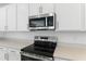 Stainless steel appliances and light gray countertops in this modern kitchen at 2027 Stetson Ct, Eagle Lake, FL 33839