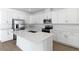 Modern kitchen featuring white cabinets, quartz countertops, and stainless steel appliances at 2027 Stetson Ct, Eagle Lake, FL 33839