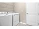 Laundry room with washer, dryer, and shelving at 891 Griffon Ave, Lake Alfred, FL 33850