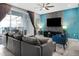 Bright and airy living room with comfortable seating, a large TV, and access to a balcony at 3725 Pacific Ln, Davenport, FL 33897