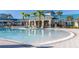 Community pool with a large deck and palm trees at 3725 Pacific Ln, Davenport, FL 33897