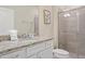 Bathroom with granite countertop, white cabinets, and a shower at 3725 Pacific Ln, Davenport, FL 33897