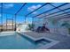 Screened pool and spa with a whimsical Disney mural at 3725 Pacific Ln, Davenport, FL 33897
