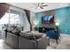 Living room with comfortable seating, large TV, and sliding glass doors leading to a patio at 3725 Pacific Ln, Davenport, FL 33897