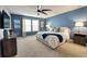 Bedroom with king-size bed, ceiling fan, and large windows at 3725 Pacific Ln, Davenport, FL 33897