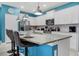Modern kitchen with white cabinets, granite island, and blue walls at 3725 Pacific Ln, Davenport, FL 33897