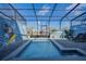 Relaxing pool with a fun Mickey Mouse mural and screen enclosure at 3725 Pacific Ln, Davenport, FL 33897