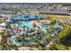 Aerial view of a community water park with slides and a lazy river at 3725 Pacific Ln, Davenport, FL 33897