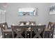 Dining room with six-chair table and a mirror reflecting the living room at 3725 Pacific Ln, Davenport, FL 33897