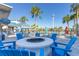 Circular fire pit surrounded by blue Adirondack chairs at 3725 Pacific Ln, Davenport, FL 33897