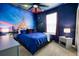 Bedroom with a king-size bed, a mural of Cinderella's castle, and a ceiling fan at 3725 Pacific Ln, Davenport, FL 33897