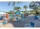 Resort-style pool deck with tables, chairs, and umbrellas at 3725 Pacific Ln, Davenport, FL 33897
