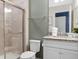 Bathroom with granite countertop, white cabinets, and a shower at 3725 Pacific Ln, Davenport, FL 33897