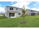 Two-story home with covered patio and grassy backyard at 1416 Maddie Berry Ln, Kissimmee, FL 34744