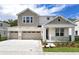 Two-story home with neutral siding and a three-car garage at 1416 Maddie Berry Ln, Kissimmee, FL 34744