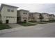 Row of townhouses with attached garages and landscaping at 2060 Cypress Bay Blvd, Kissimmee, FL 34743